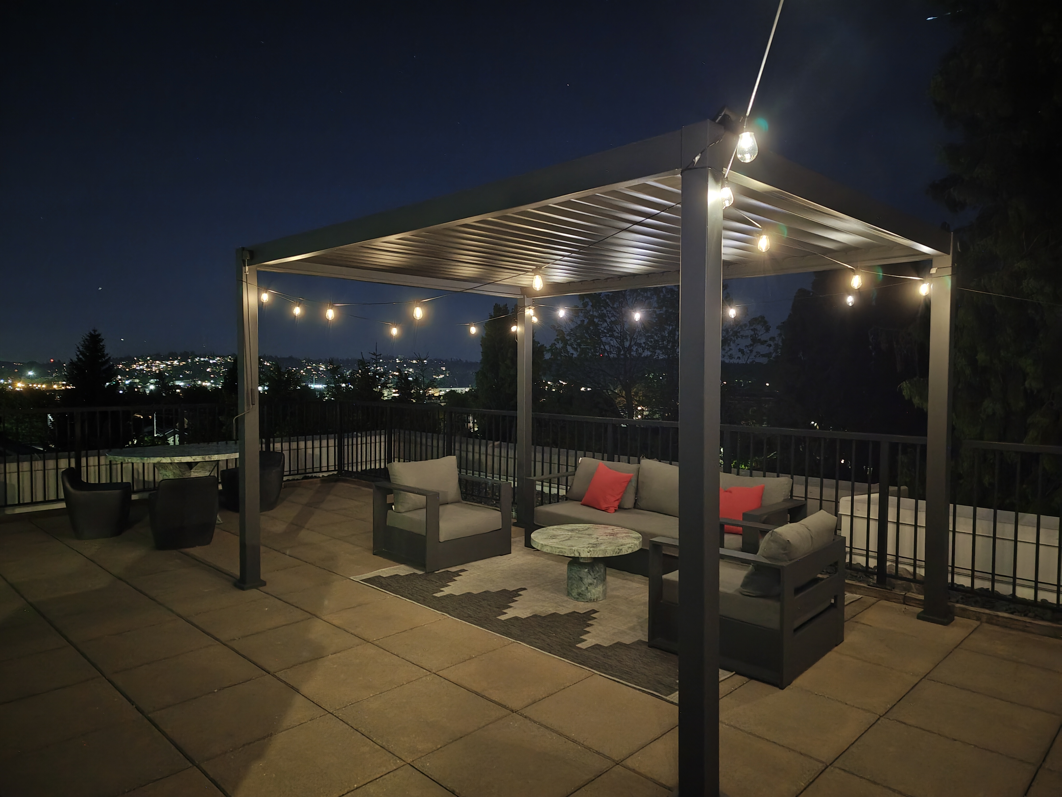 A pergola at night with lights
