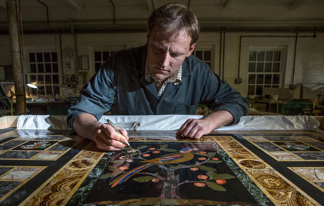 Thomas Greenaway working on a pietra dura from Lotherton Hall in West Yorkshire he is currently restoring at his Northamptonshire workshop. The Decorative Arts Society has funded the conservation work in advance of an exhibition marking Lotherton’s 50th anniversary as a museum. The table was bought with the aid of a grant from the National Art Collections Fund in 1971. It was designed by William Burges for himself, for his house on Buckingham Street. It was later moved to his grand gothic mansion he designed for himself, the Tower House in Kensington (now owned by Jimmy Page!). It was apparently used by him for special occasions, when he would place many of his most important treasures atop it. The fact that parrots were his favourite bird perhaps adds extra resonance.