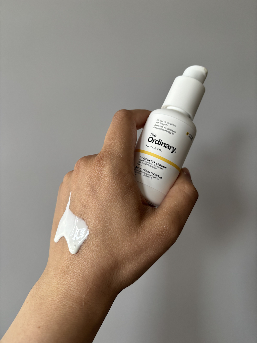 Mica Ricketts showing texture of The Ordinary UV Filters SPF 45 Serum on back of hand