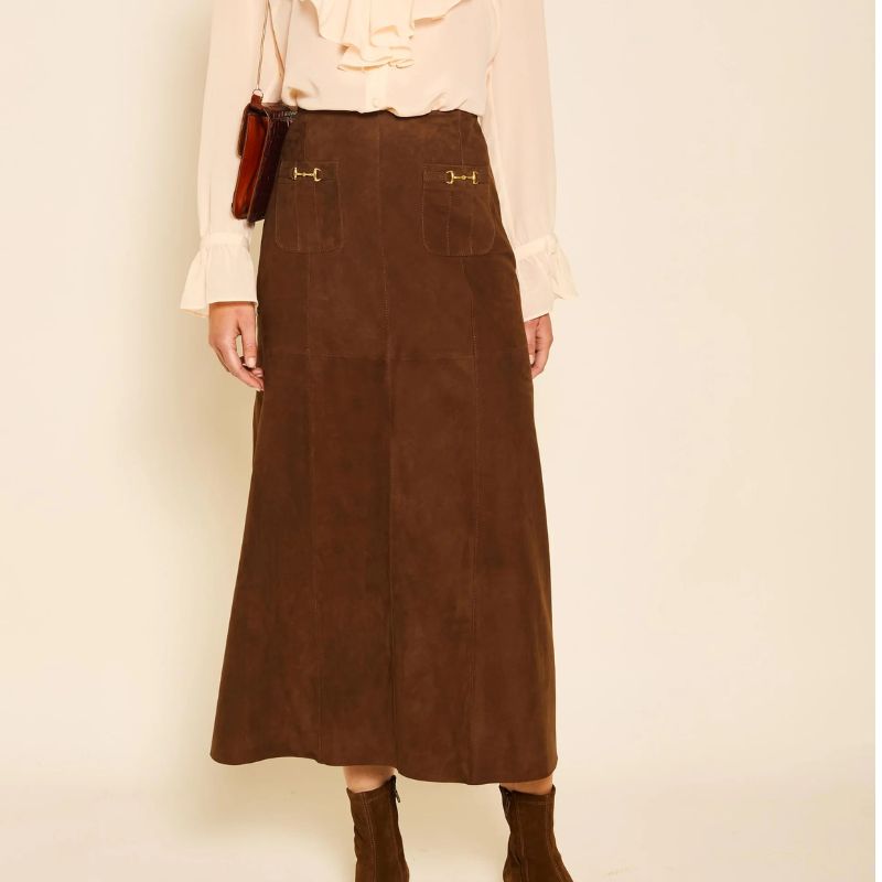 A MODEL WEARING A BROWN RIXO SKIRT