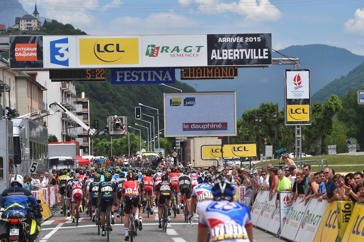The riders pass through the finish line for the first time