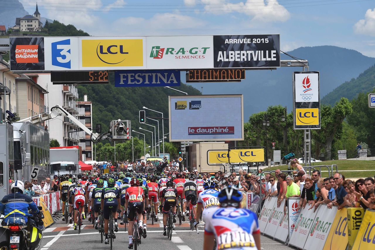 The riders pass through the finish line for the first time