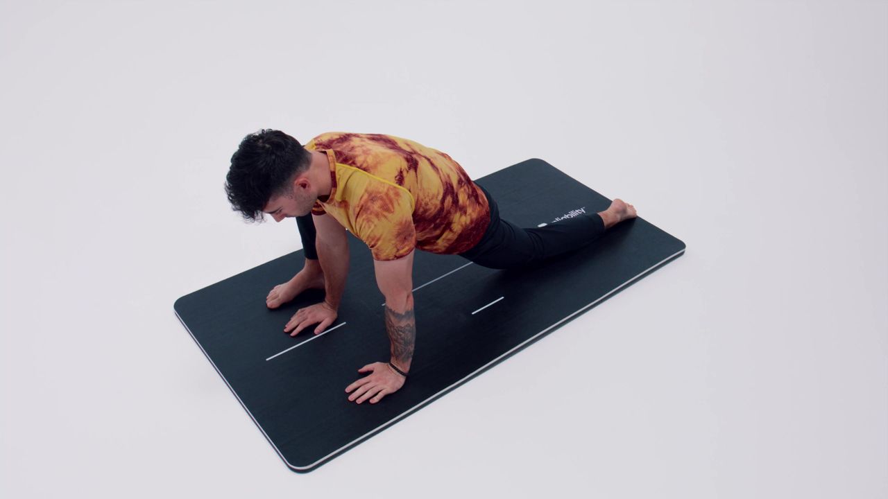 A Pliability athlete demonstrating the lizard stretch
