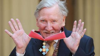 Leslie Phillips poses with his award after receiving his CBE from Queen Elizabeth II on May 7, 2008.