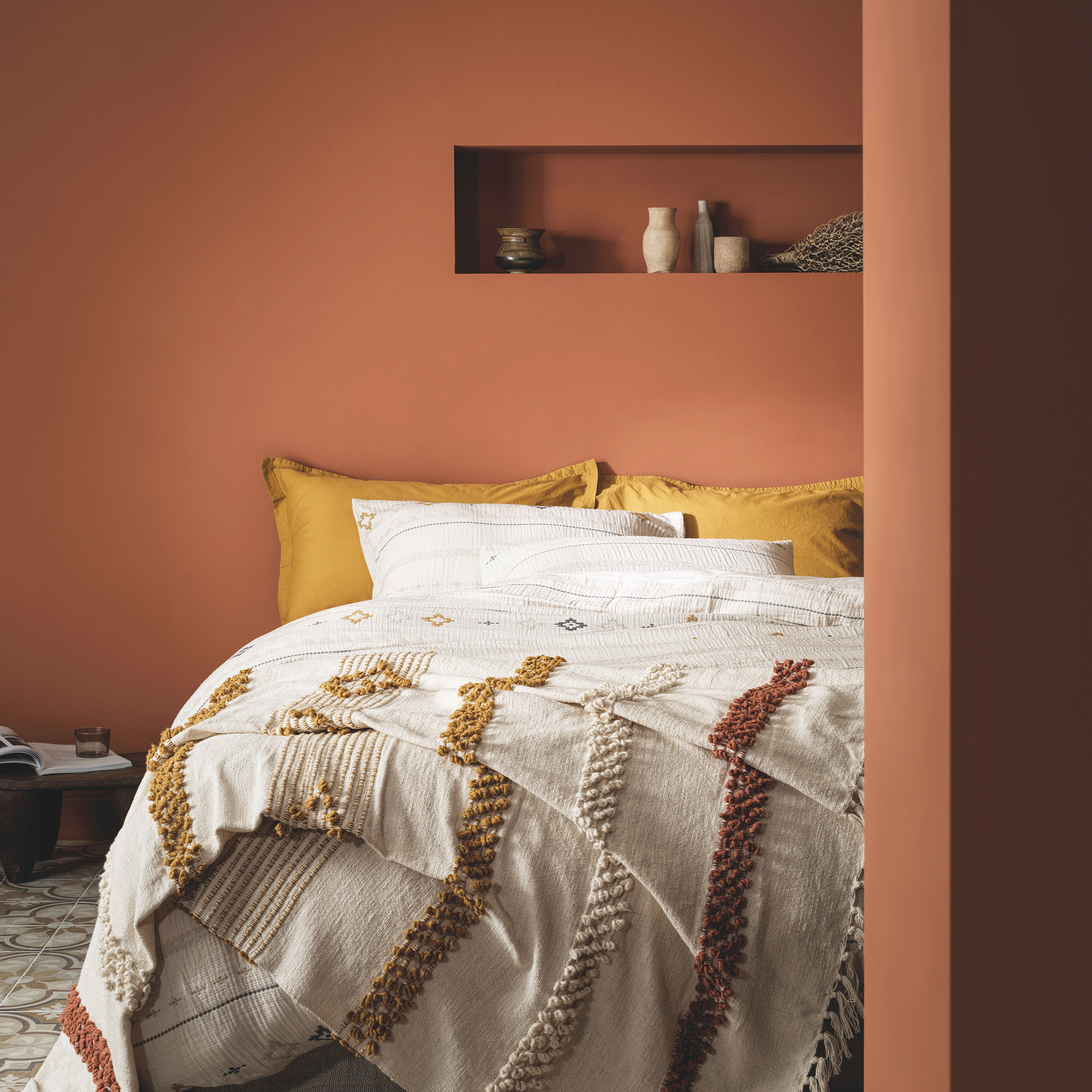 Terracotta bedroom with white bed