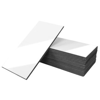 A stack of white rectangular peel and stick tiles