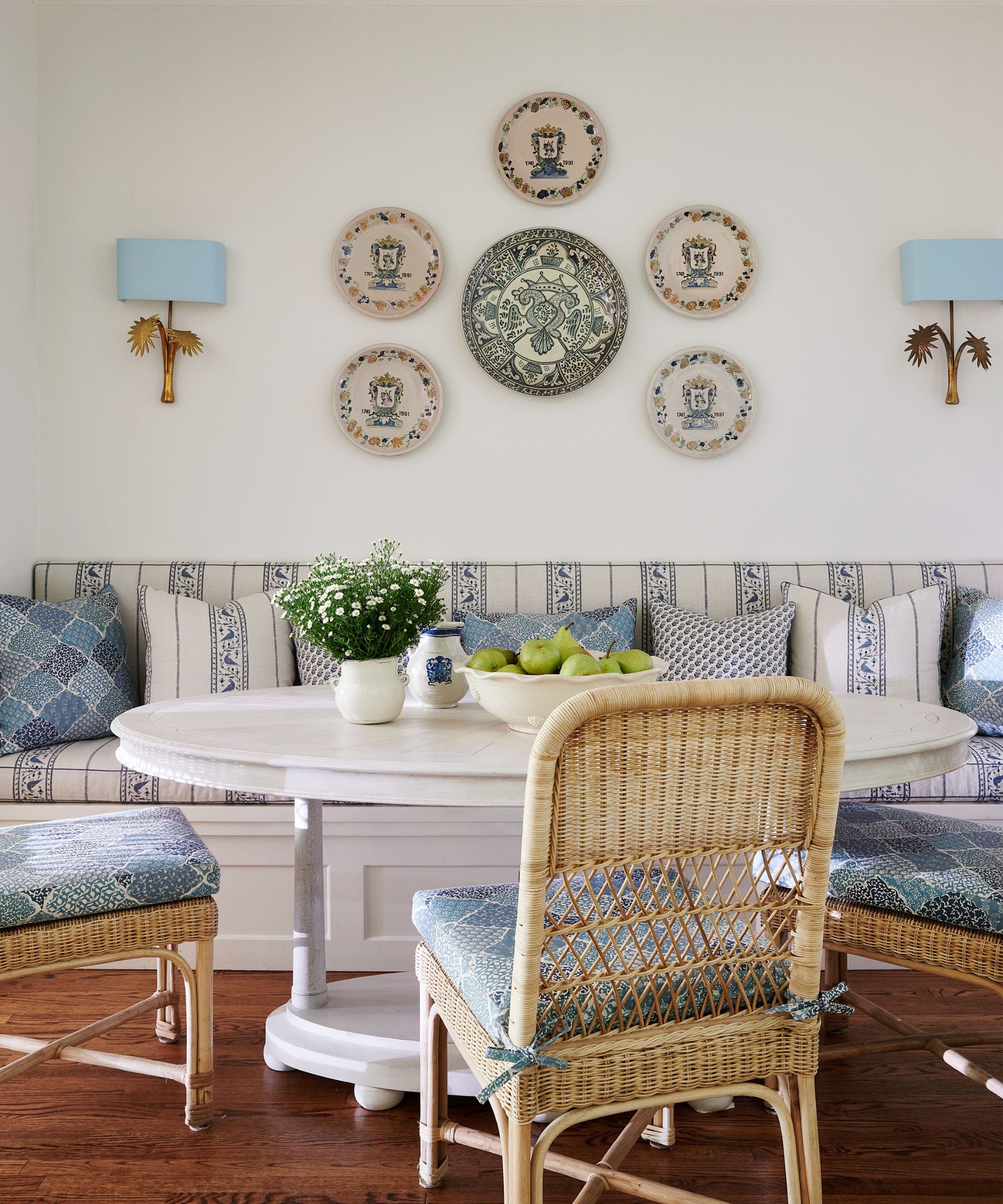 dining nook with plates on wall and bench seat