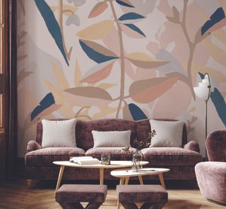 Living room with dark neutral sofa and armchair large trailing leaf wallpaper