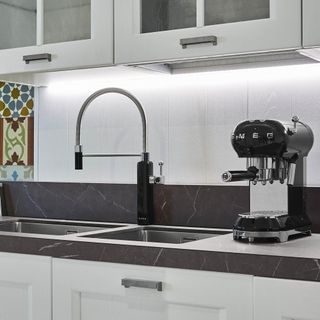 kitchen with black smeg tap with back coffee machine