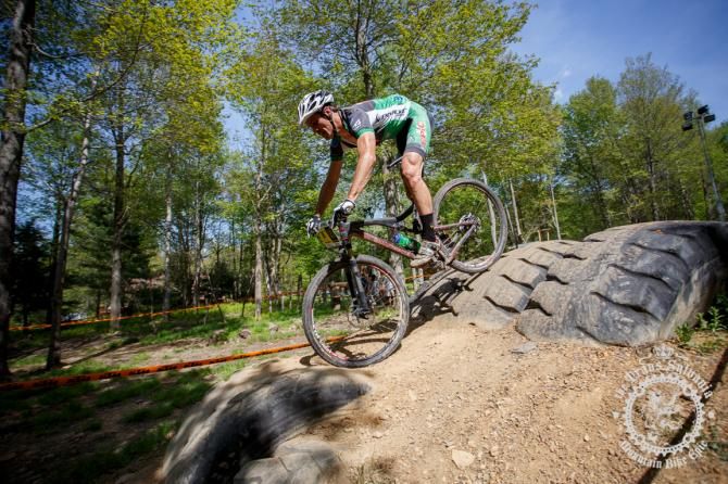 Matt Williams (mtbracing.com) rolls smoothly ove r a mound of tires