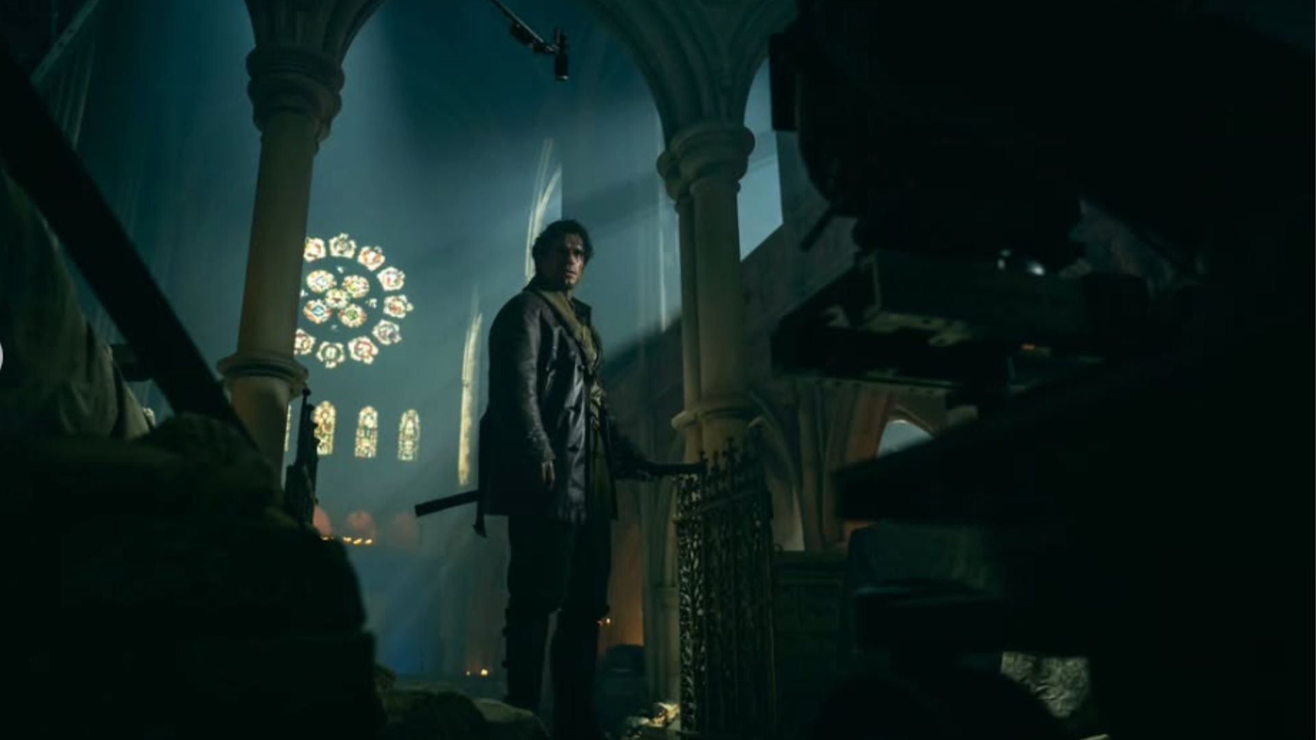 an image of henry cavill as highlander in a dark Church standing in front of a stained glass window