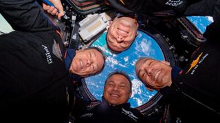 The four astronauts of Axiom Space's Ax-3 mission smile while floating in the Cupola observation module of the International Space Station before undocking on Feb. 7, 2024.