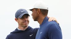 Rory McIlroy and Tiger Woods during a practice before the 2023 Masters