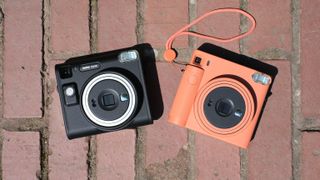 Fujifilm Instax SQ1 next to the Instax SQ40 instant film cameras