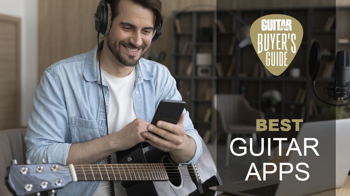 Man with acoustic guitar, holding his phone 