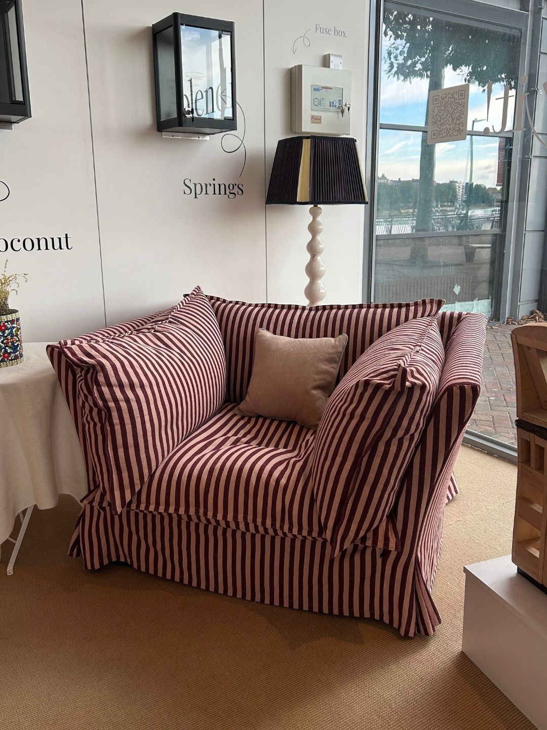 The Vesper armchair in pink Rhubarb &amp; Rose striped linen from the Piglet in Bed collaboration, featuring a high back with plush cushions and tailored skirt.