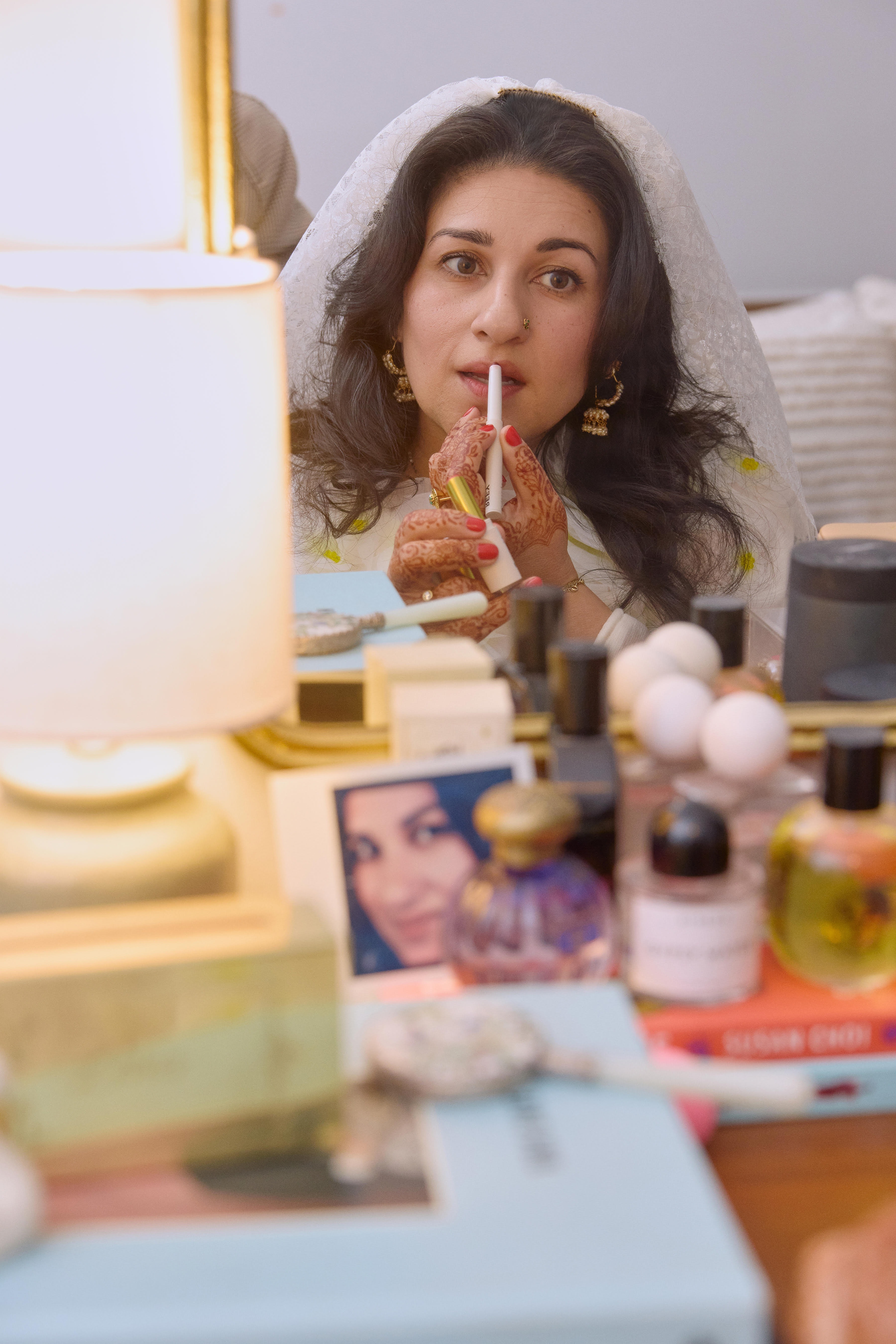 Kirin Bhatty applying a lip product on her wedding day.