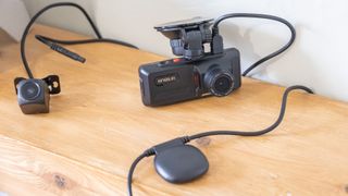 Kingslim D1 dash cam's front camera, rear camera, and GPS unit