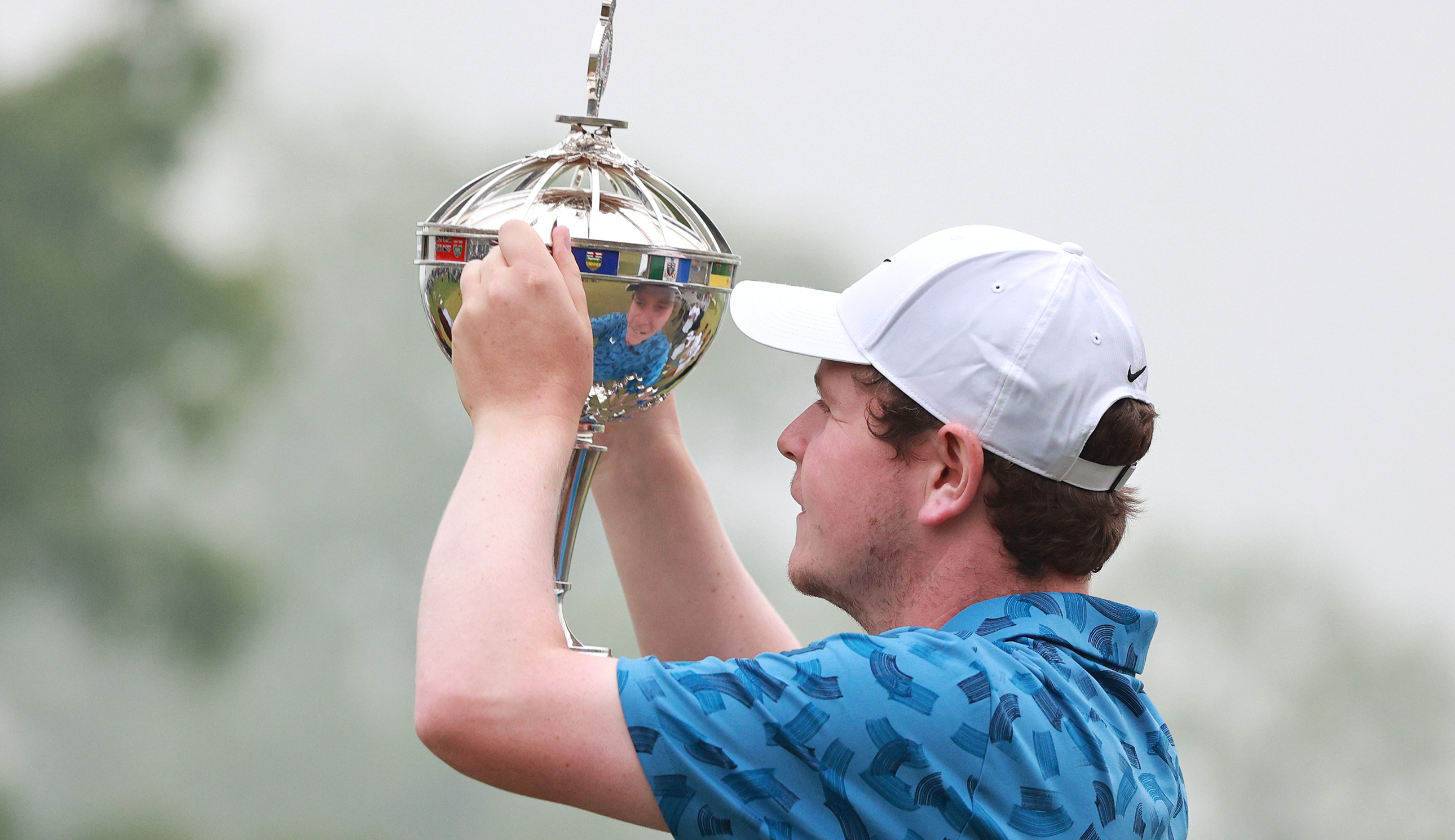 Robert MacIntyre holds the RBC Canadian Open trophy aloft