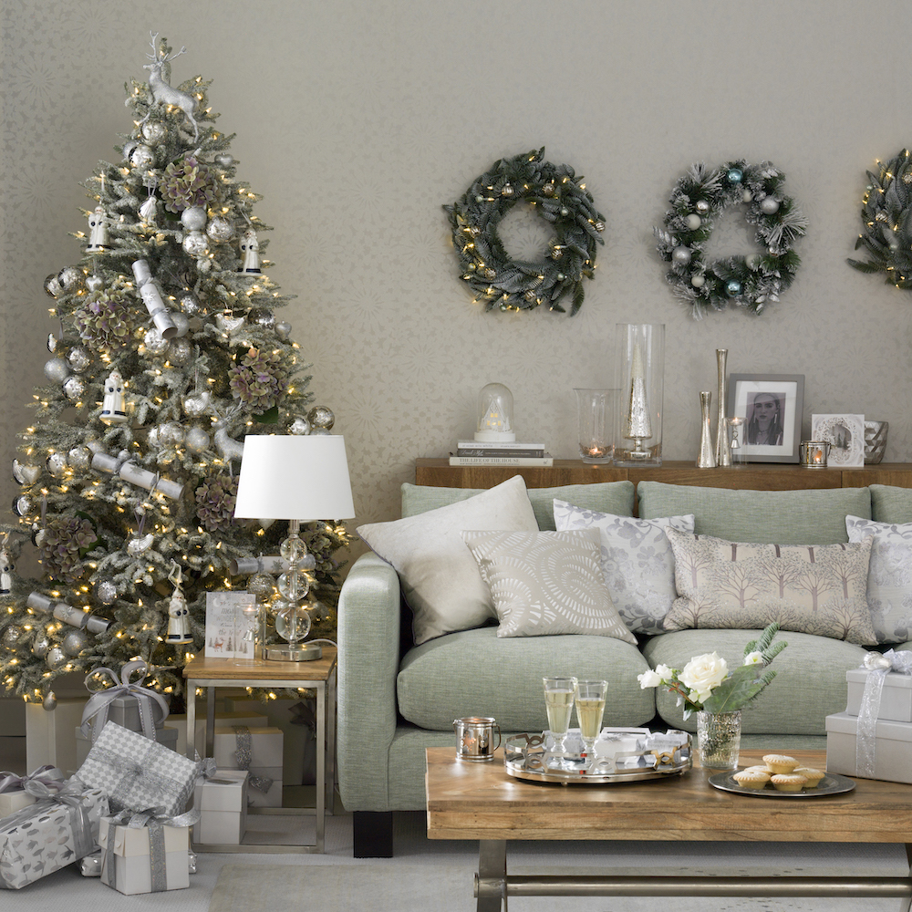 Pale green Christmas living room with three wall mounted wreaths