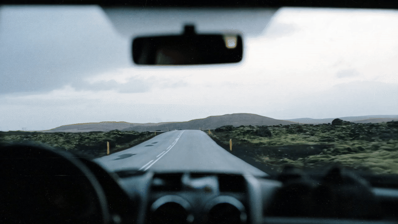 Motion gif of the view out of a car windshield driving along a road in Iceland