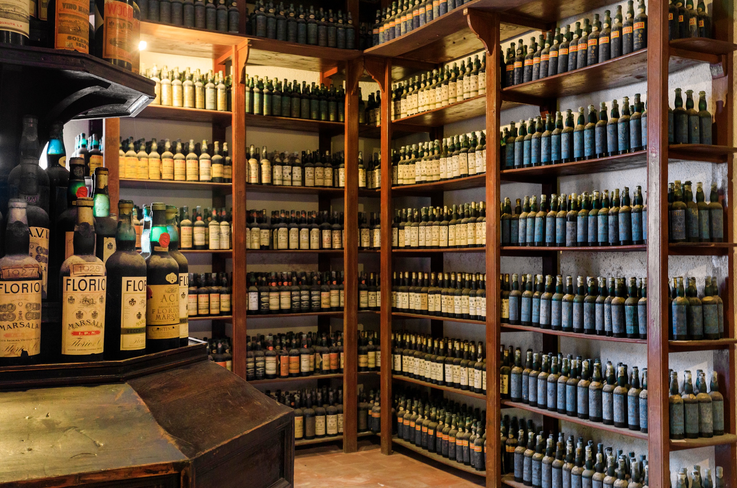 Room with floor to ceiling shelves full of Florio Marsala bottles