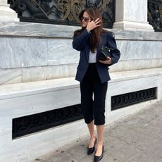 Eliza Huber wearing a COS blazer, capri pants, and flat shoes to the COS S/S 25 runway show in Athens, Greece.