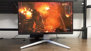 A photo of a BenQ MOBIUZ EX321UX gaming monitor on a desk