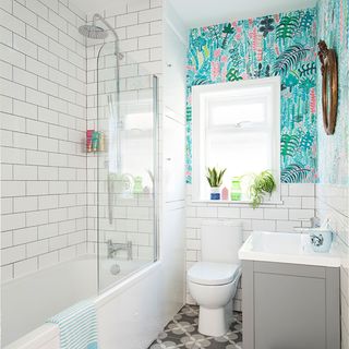 white bathroom with wall tiles and bathtub