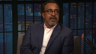 Tim Meadows looking at to his right on Late Night with Seth Meyers.