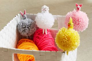 Easter pom pom animals in various colours in white basket