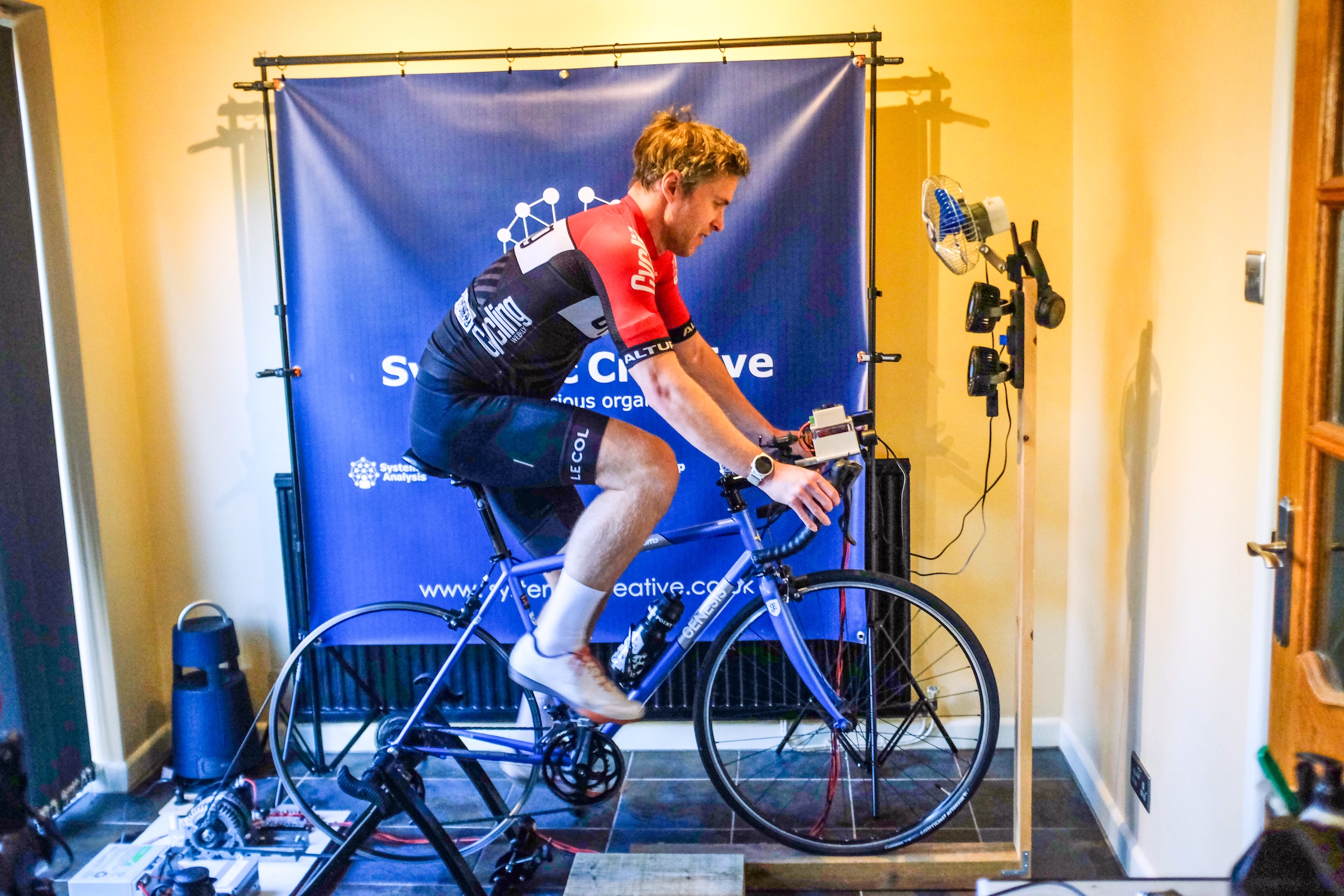 David Bradford shot in profile riding on the Systemic Creative turbo trainer