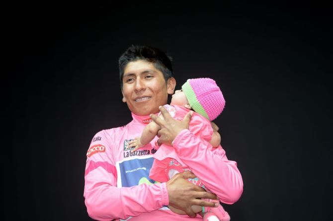 Nairo Quintana takes his newborn baby onto the podium