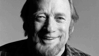 Stephen Stills posing for a photograph in 2011