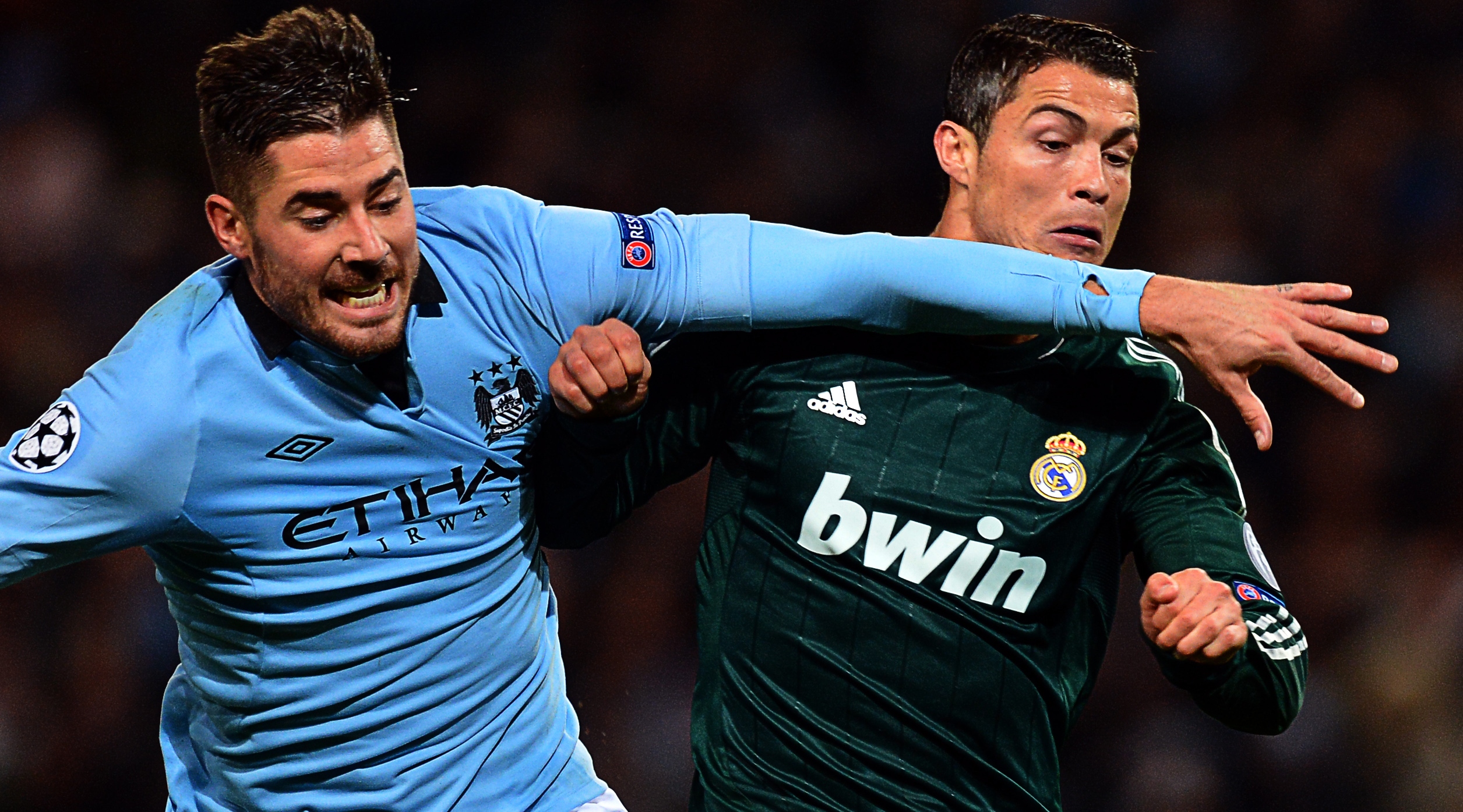 Real Madrid's Portuguese forward Cristiano Ronaldo (R) vies with Manchester City's Spanish midfielder Javi Garcia during the UEFA Champions League group D football match between Manchester City and Real Madrid at The Etihad Stadium in Manchester, north-west England, on November 21, 2012. AFP PHOTO / PAUL ELLIS (Photo credit should read PAUL ELLIS/AFP via Getty Images)