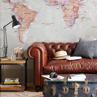 living room with wall map and leather sofa