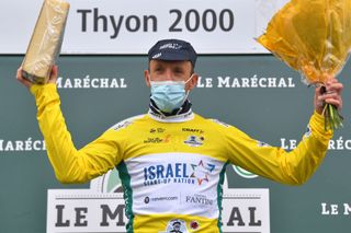 THYON 2000 LES COLLONS SWITZERLAND MAY 01 Michael Woods of Canada and Team Israel StartUp Team Yellow Leader Jersey celebrates at podium during the 74th Tour De Romandie 2021 Stage 4 a 1613km stage from Sion to Thyon 2000 Les Collons 2076m Cheese Trophy Mask Covid Safety Measures TDR2021 TDRnonstop UCIworldtour on May 01 2021 in Thyon 2000 Les Collons Switzerland Photo by Luc ClaessenGetty Images