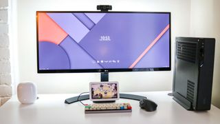 A Nest Wifi Pro on a desk next to a monitor and PC