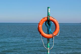 A life buoy with the sea in the background