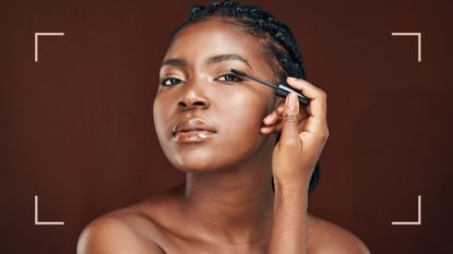 Can you put mascara on lash extensions? Image of woman applying mascara