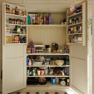 Open larder unit in a cream painted kitchen