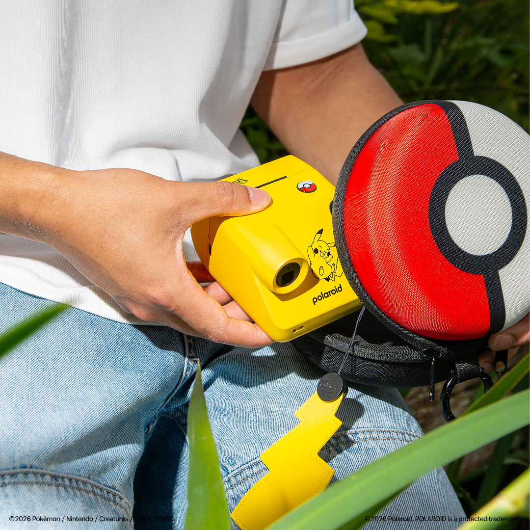Pikachu-styled Polaroid Go camera being placed inside a Poke Ball style case