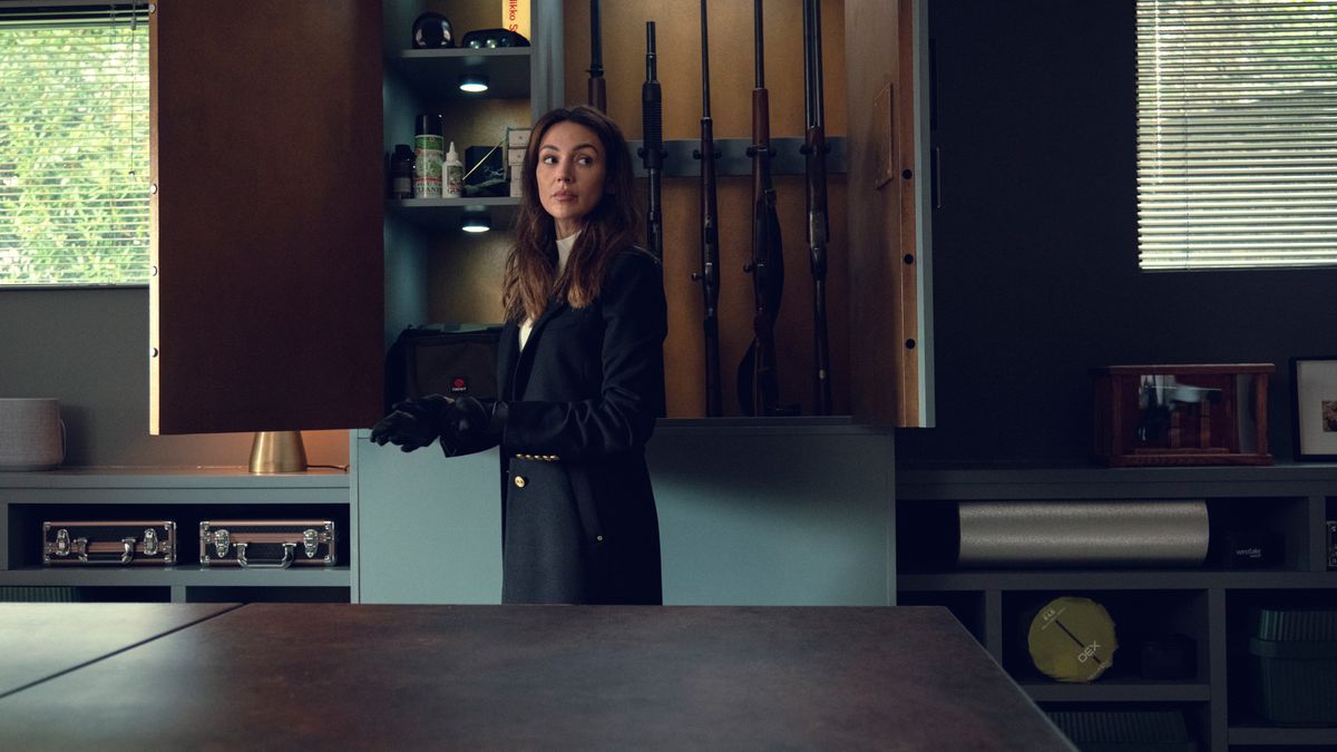 Maya (Michelle Keegan) in front of a wall of guns in Netflix&#039;s Fool Me Once