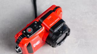 A red Kodak PIXPRO WPZ2 compact camera