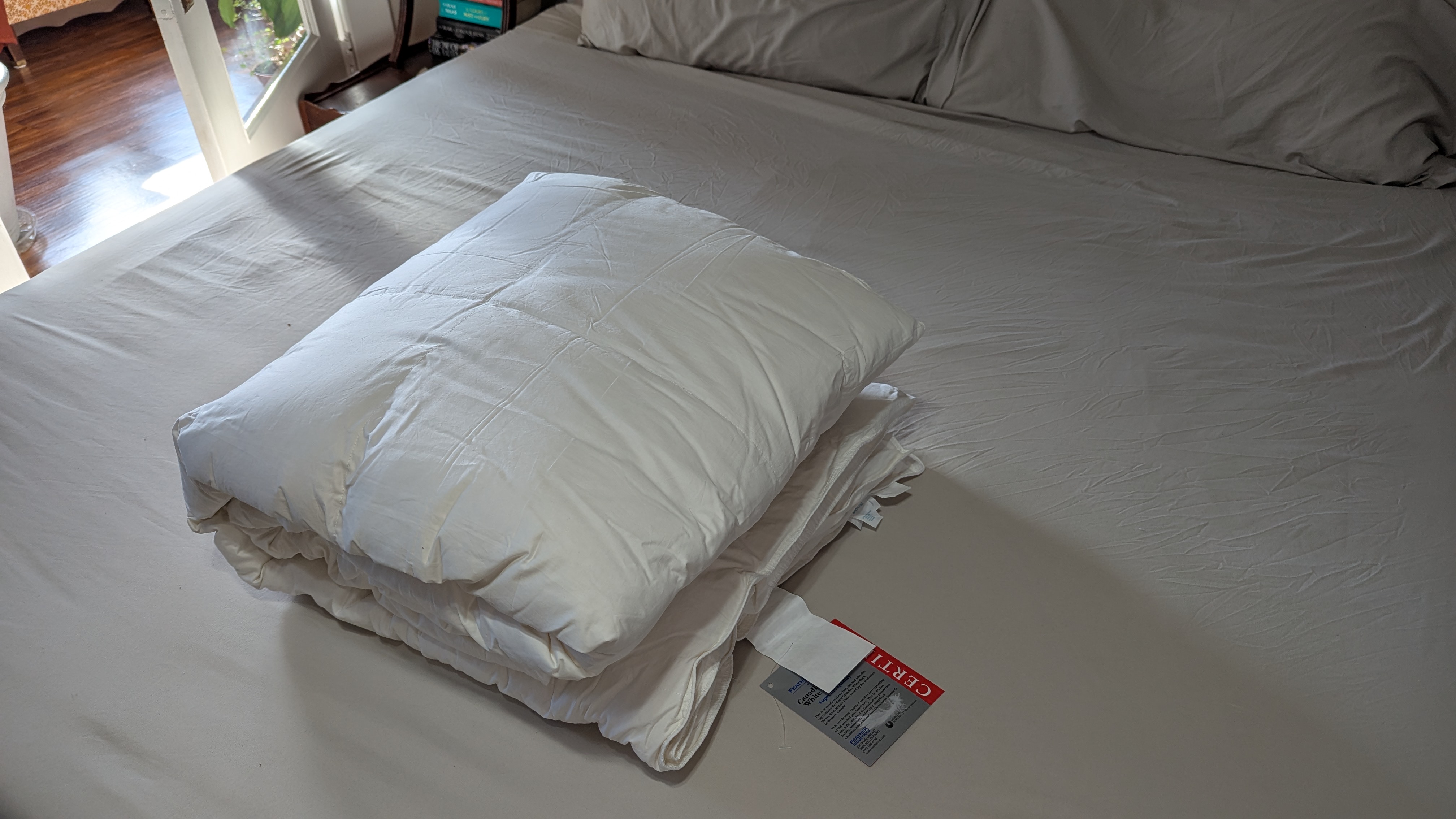 A white down comforter in bed