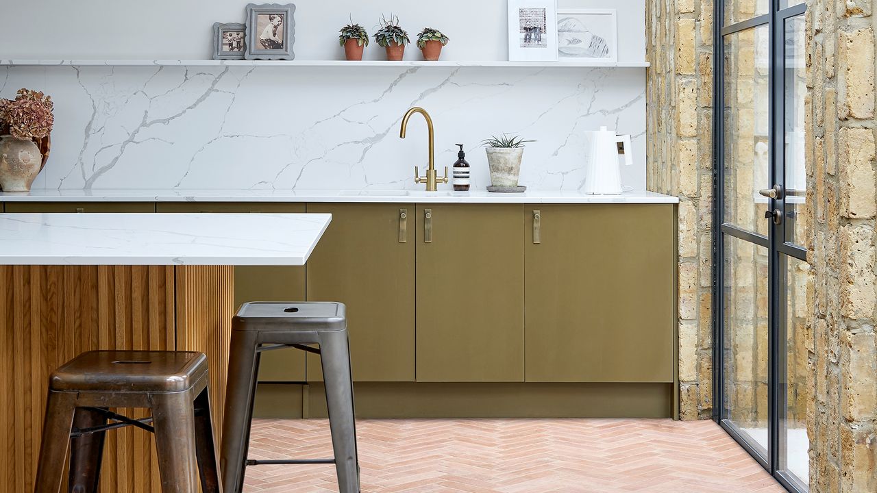 Green kitchen with terracotta floor tiles