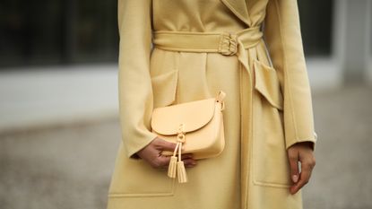 best belted winter coats: street style model wearing yellow belted coat