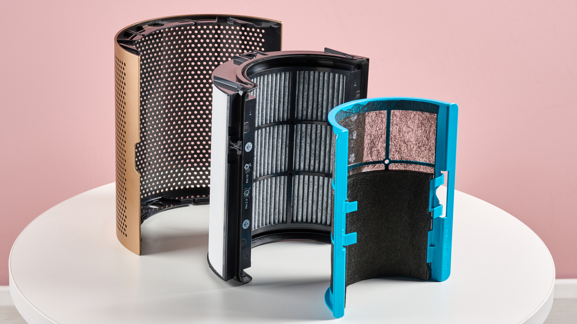 catalytic filter, HEPA H13 filter, and the outer plastic shroud are arranged on a tabletop.