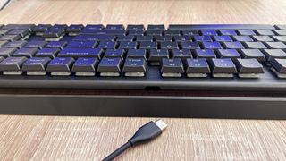 Cherry MX 10.0N RGB keyboard on desk, photographed from rear to show usb cable disconnecting
