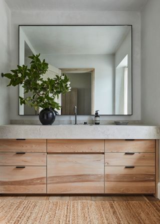 bathroom with wooden vanity and large mirror
